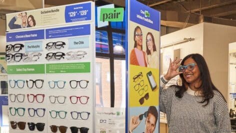 A customer tries on top frames at a Pair Eyewear in-person display.