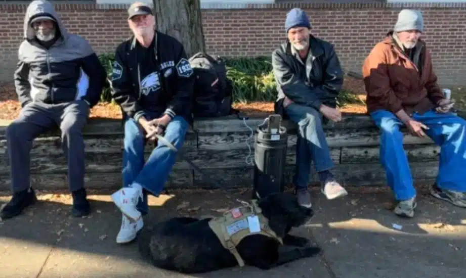Chuck Jones and his dog, Midnight (center left) enjoying time with residents at Breaking Bread Community, a pet-friendly homeless shelter in Upper Darby.