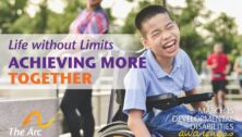 A laughing boy in a wheelchair on a Arc of Chester County poster promoting March as Developmental Disabilities Awareness Month.
