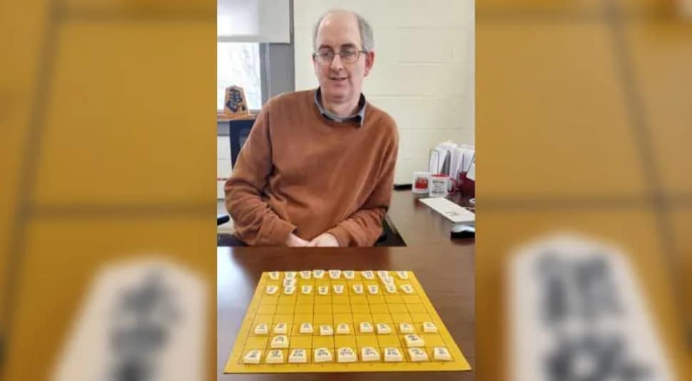 Swarthmore College professor Alan Baker sits with a shogi board, part of the Swarthmore College Shogi Club