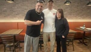 Johnny Paisano’s owner Johnny Minicozzi, left, and his wife Christine with contractor Russell D. Rhoads of Brookhaven, who transformed a former H & R Block building into the new restaurant.