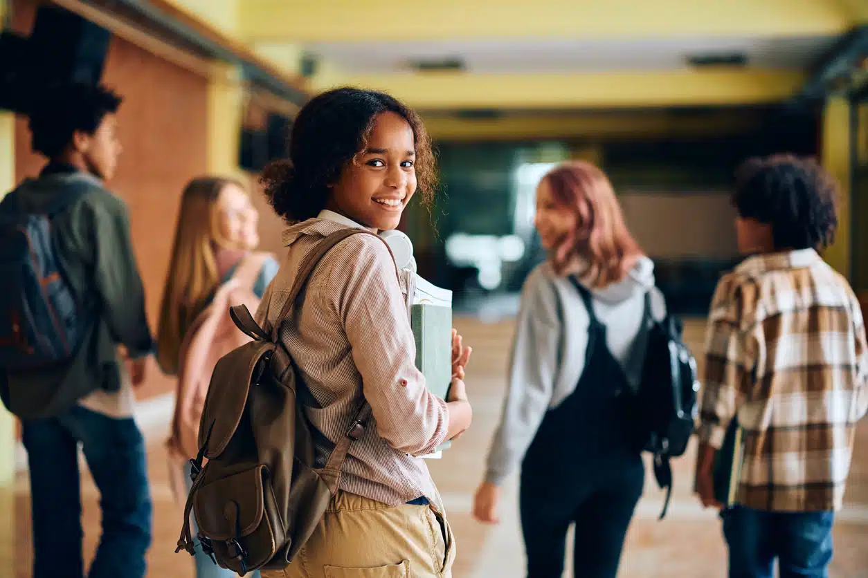 High school students walking in a school hallway.