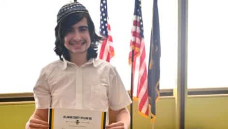 Hillel Ziskind, an eighth grader at the Grayson School in Radnor, holds up his spelling bee certificate after winning this year's Delaware County Spelling Bee.