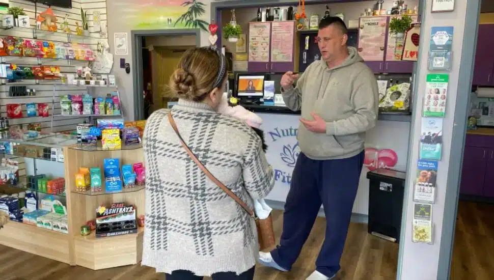 Bill Moss speaks with a customer about his cannabinoid products.