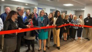 County officials and dignitaries join Fair Acres staff in cutting the ribbon celebrating the completion of renovations to the 10th, 11th and 12th floors of Building 8.