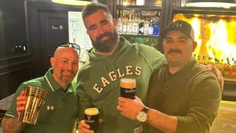 Jason Kelce joins wo customers holding a pint of Guinness at Media's Towne House.