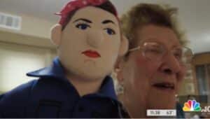 June Robins of Media poses with a Rosie the Riveter doll.