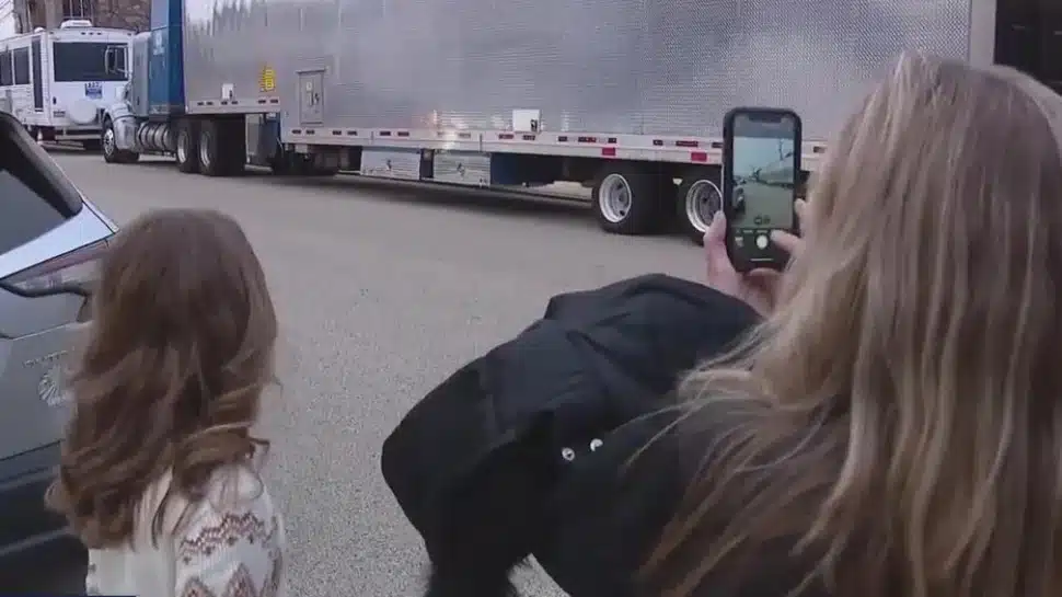 Residents snap some photos across the street from where film crews are shooting a reported sequel to 'Mare of Easttown,' 'Task.'