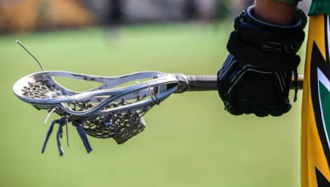A player holding a lacrosse stick.