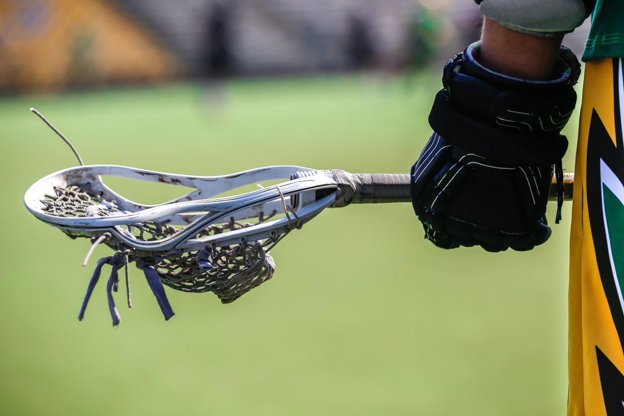 A player holding a lacrosse stick.