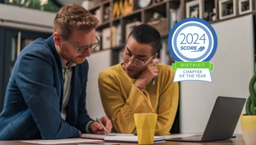 A SCORE mentor helping a small business owner.