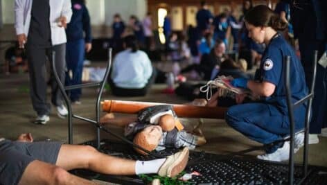 A Widener University nursing student offers first aid and triage.