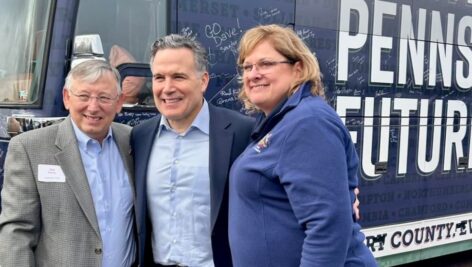 Republican U.S. Senate Pennsylvania candidate Dave McCormick poses for a picture with a man and woman during his campaign.