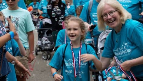 Arc of Chester County CEO Jeanne Meikrantz honors a young walker.at the May 19, 2024 Bubble Walk & Fun Day