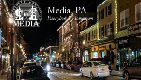 A night image post card of Media Borough's downtown business district.