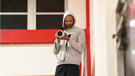 Shawn Rodgers with his camera shooting for his RareFootage Sports media brand.