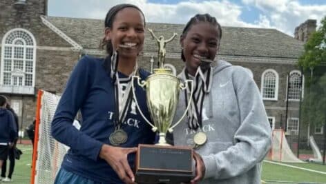 Saige Forbes (left) and Avery Elliott with the Inter-Ac trophy, which the school hadn't won in girls' track and field since 2015.