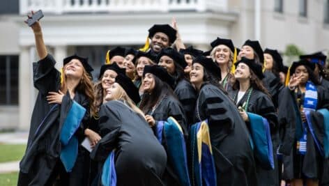 New graduates of Widener University capture a special moment in time at Commencement with a group selfie.