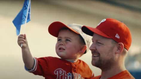 A father and son check out a homemade Delco flag.