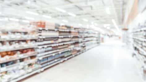 Blurred image of store shelves stocked with merchandise