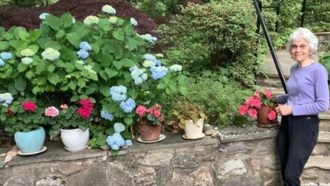 Anne Pearlman poses with some of her garden work.