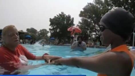 Sharifa Jackson, a reporter with 6abc, receives a swimming lesson from Nellda Harris at the Nile Swim Club in Yeadon.