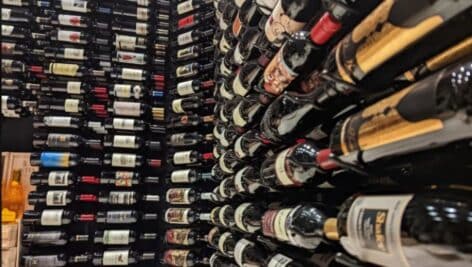 The wine cellar at Tecca Newtown Square restaurant showing rows and rows of wine bottles.