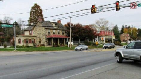 An intersection in Chadds Ford, Pennsylvania with a historical building in the distance.