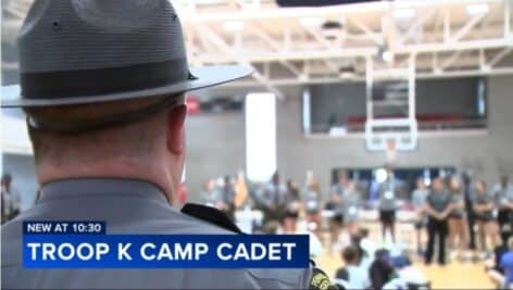 A Pennsylvania state trooper addresses a room full of campers at Troop K Camp Cadet.