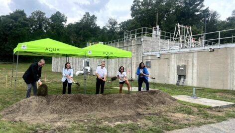 Members of Aqua and breaking ground/shoveling dirt at the new treatment plant at Crum Creek.