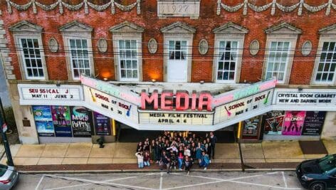 Looking down on the Media Theatre marquee in Media where a crowd gathers before a film festival.