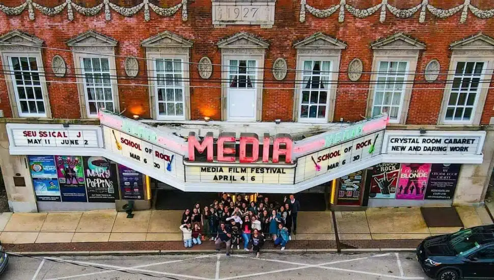 Looking down on the Media Theatre marquee in Media where a crowd gathers before a film festival.