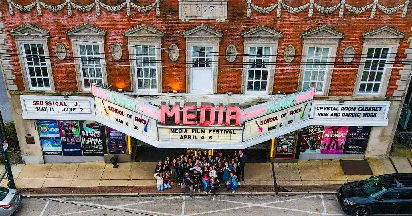 Looking down on the Media Theatre marquee in Media where a crowd gathers before a film festival.