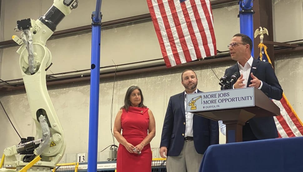 Pa. Gov. Josh Shapiro (at podium) visits Production Systems Automation Inc. to unveil a new state program. At left are Michelle Mikitish, president of the Greater Pittston Chamber of Commerce, and state Rep. Aaron Kaufer, a Republican from Kingston.