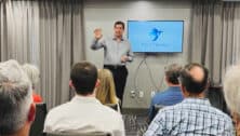 A man from Pivot Mindset gives a talk to a room full of people.