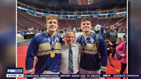 Sun Valley High School wrestling coach Tommy Ellis with two of his players.