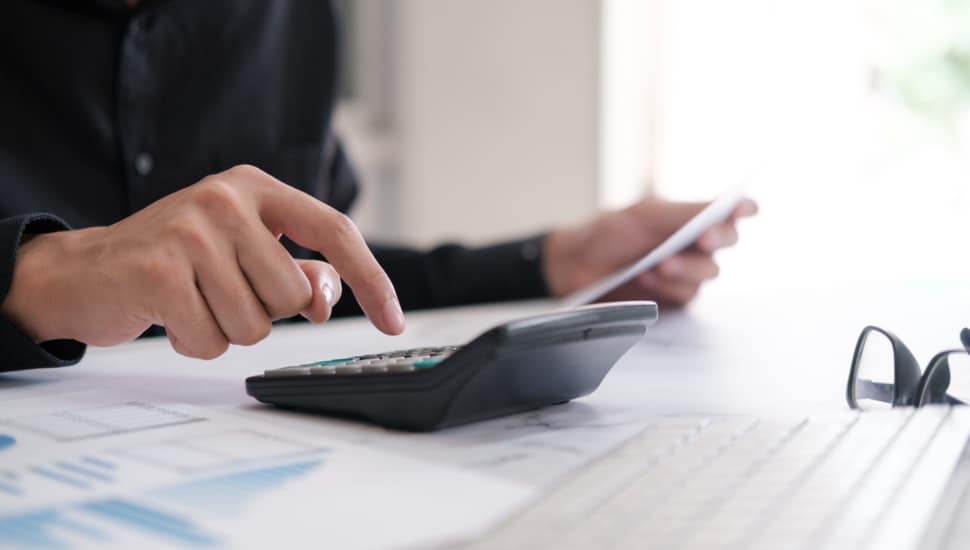 Business man using calculator.