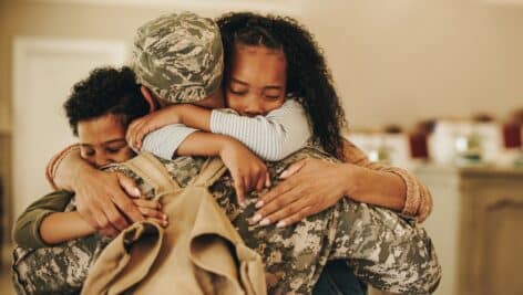 Soldier embracing his wife and kids