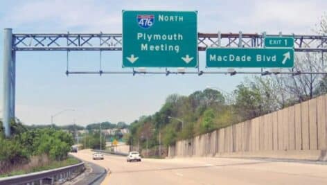 A view from the Blue Route of two road signs, including one for the exit to MacDade Blvd.