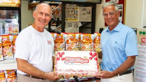 Peter Romano and Ed Herr pose with the winning chips.