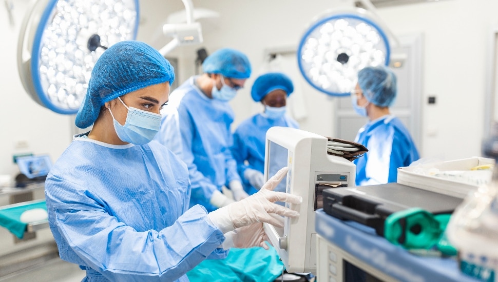 Anesthesiologist keeping track of vital functions of the body during cardiac surgery.