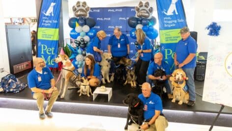 Stress-relieving dogs and their owners gather for a 5-year anniversary party at the Philadelphia International Airport.