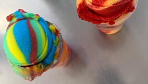 Two unique flavors of water ice in a cup.