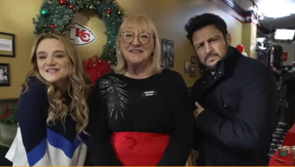 Donna Kelce appears on the set of “Holiday Touchdown” with Hunter King and Tyler Hynes.