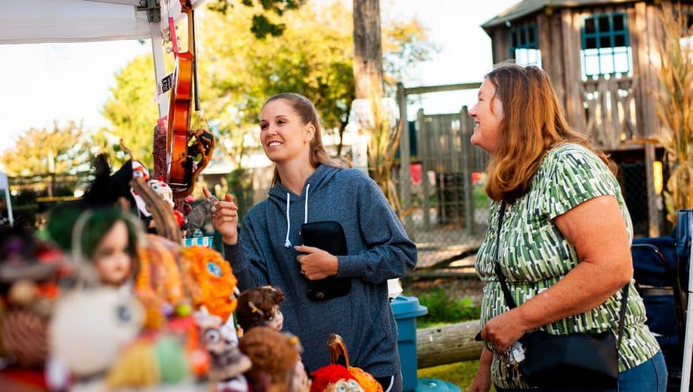 Two women enjoy a fall visit to Linvilla Orchards.