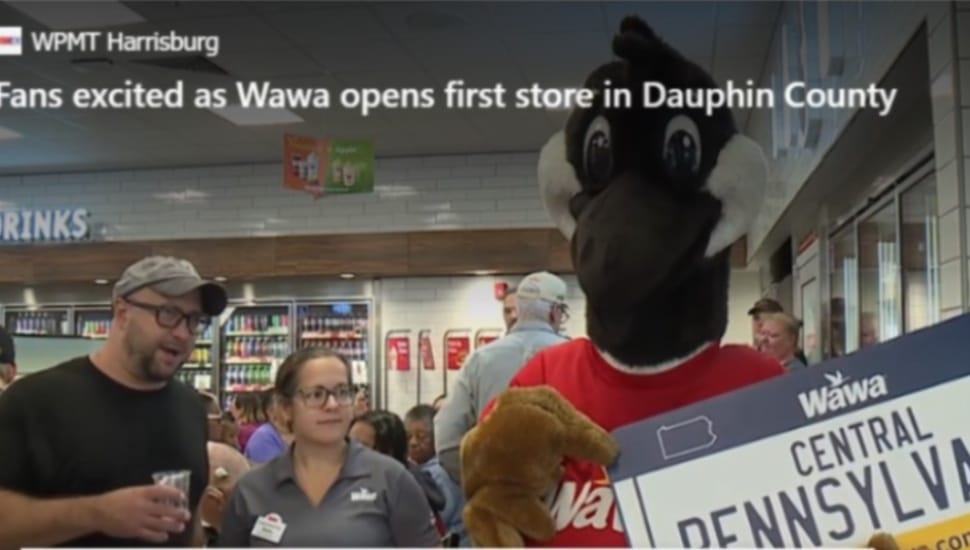 Wawa mascot Wally Goose holds a sign inside the new Dauphin County store announcing the Central Pennsylvania store is now open for business.