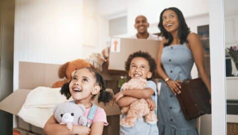 A man and woman with two children move into their new home.