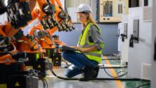 Female engineer checking and controlling parts of robotic machine. According to the October 2024 Manufacturing Business Outlook Survey, manufacturing activity in the Philadelphia region expanded overall.