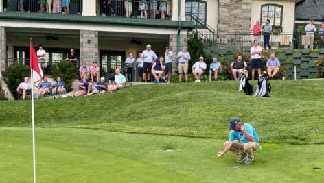 A golfer prepares a putt on the Llanerch Country Club golf course in Havertown.