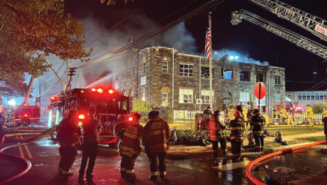 Firefighters gather outside St. Francis of Assisi School Oct. 7.